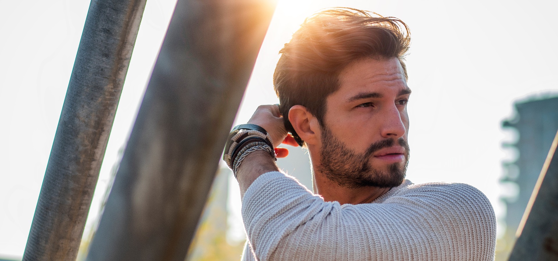 One handsome young man in urban setting in european city standing jpg